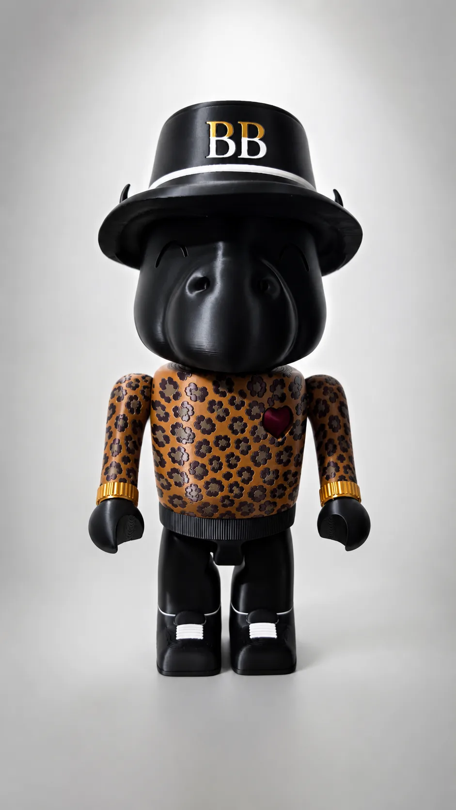 Cheetah Print, a one of one Happi Buffalo in a leopard print sweater with gold cuffs and a BB bowler hat